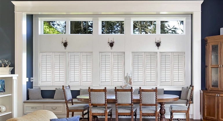 Charlotte dining room with shut plantation shutters.